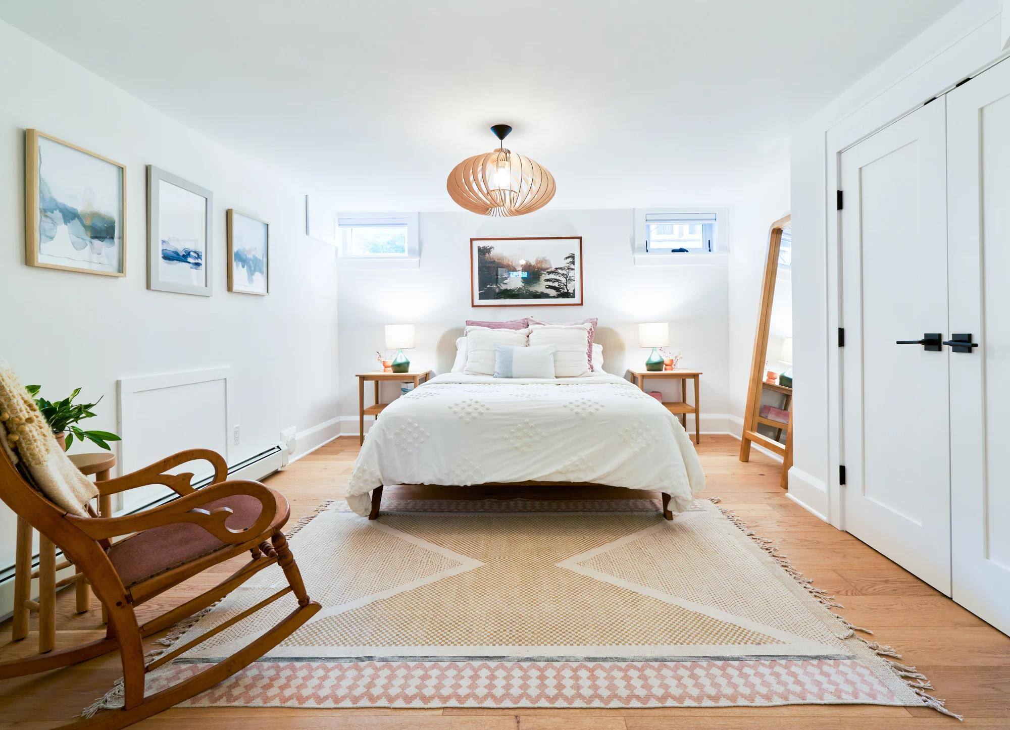 Remodeled basement bedroom with natural light, bathroom and closet by Hanson Remodeling