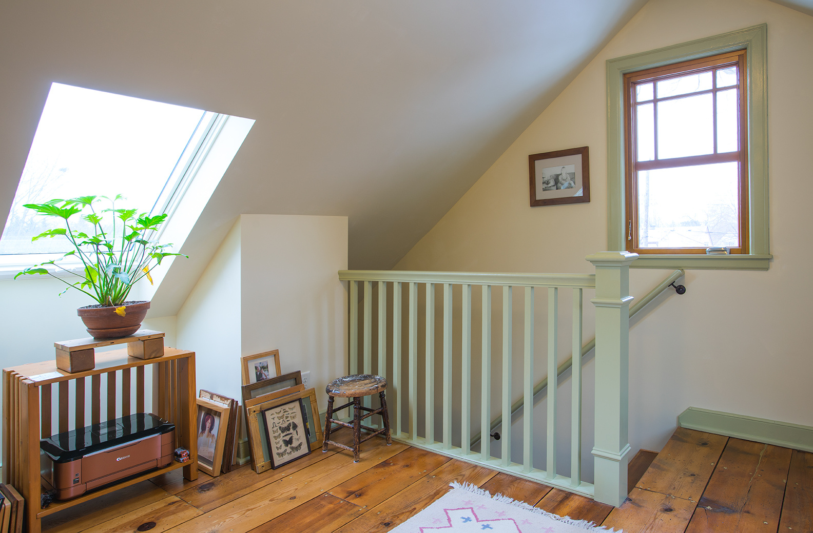 Remodeled attic with natural lighting, plants and decor by Hanson Remodeling