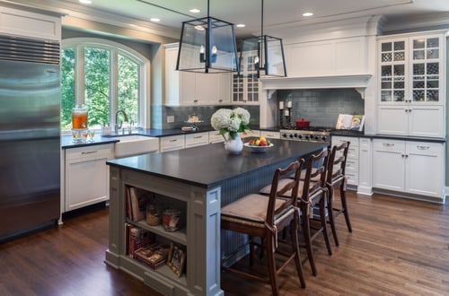 Remodeled kitchen featuring an island with storage and barstools by Hanson Remodeling